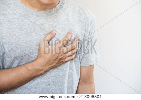 a man touching his heart. Heart attack, heart failure, others heart disease concept