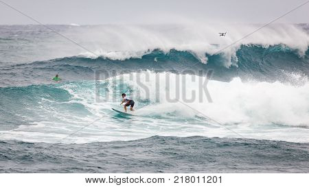 SUNSET BEACH HAWAII USA - DECEMBER 2, 2017: Surfer competing at the 2017 Vans World Cup of Surfing competition at Sunset Beach on Oahu's scenic North Shore. This is the second of three surfing competitions and Conner Coffin took first place.