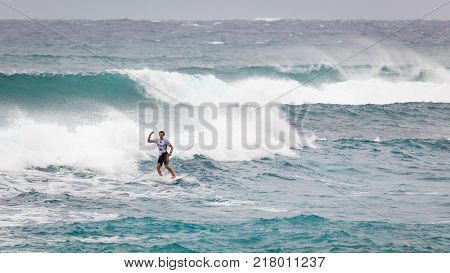 SUNSET BEACH HAWAII USA - DECEMBER 2, 2017: Surfer competing at the 2017 Vans World Cup of Surfing competition at Sunset Beach on Oahu's scenic North Shore. This is the second of three surfing competitions and Conner Coffin took first place.