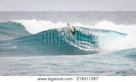 SUNSET BEACH HAWAII USA - DECEMBER 2, 2017: Surfer competing at the 2017 Vans World Cup of Surfing competition at Sunset Beach on Oahu's scenic North Shore. This is the second of three surfing competitions and Conner Coffin took first place.
