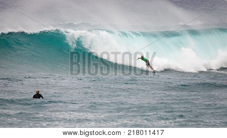 SUNSET BEACH HAWAII USA - DECEMBER 2, 2017: Surfer competing at the 2017 Vans World Cup of Surfing competition at Sunset Beach on Oahu's scenic North Shore. This is the second of three surfing competitions and Conner Coffin took first place.
