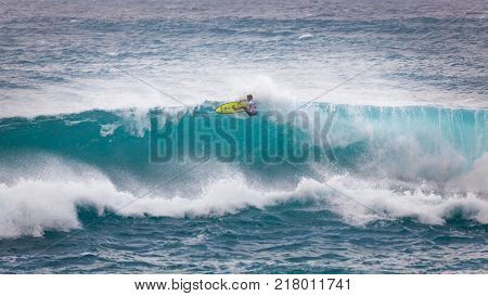 SUNSET BEACH HAWAII USA - DECEMBER 2, 2017: Surfer competing at the 2017 Vans World Cup of Surfing competition at Sunset Beach on Oahu's scenic North Shore. This is the second of three surfing competitions and Conner Coffin took first place.