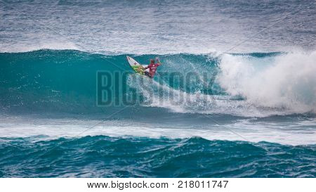 SUNSET BEACH HAWAII USA - DECEMBER 2, 2017: Surfer competing at the 2017 Vans World Cup of Surfing competition at Sunset Beach on Oahu's scenic North Shore. This is the second of three surfing competitions and Conner Coffin took first place.