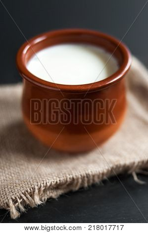Homemade curd in clay pot made from cow milk. Sour cream or natural Cottage cheese