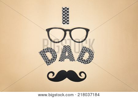 Composition with phrase I LOVE DAD for Father's Day on craft paper