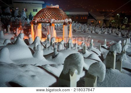 Mystical graveyard memorial in winter snow night