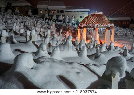 Mystical graveyard memorial in winter snow night