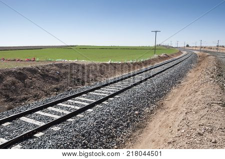 Conventional rail in an agricultural landscape in Toledo Province, Spain.