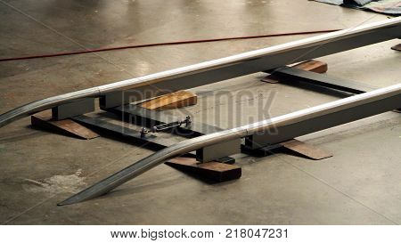 Behind the scenes of production crew team setting dolly track for camera equipment and 4K HD video shooting in a big studio.