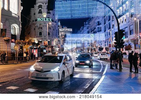 Madrid, Spain - December 8, 2017: Traffic in Gran Via Street in Madrid at night on Christmas time.