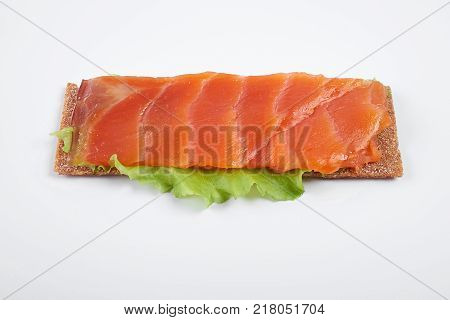 Low caloric open sandwich with red fish. Isolated on white background.