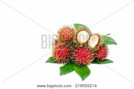 Closeup of fresh red ripe rambutan (Nephelium lappaceum) with leaves isolated on white background. Thai dessert sweet fruits. Tropical fruit.