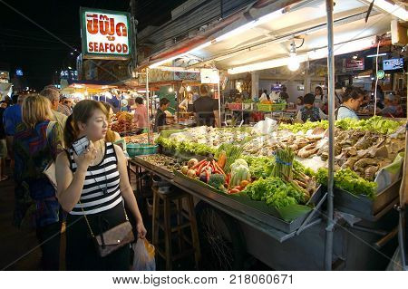 HUA HIN  THAILAND - 9 DEC 2017: Unidentified Tourists shopping and eating seafood at Hua Hin night market. Here is the biggest night market and very famous for foreign and Thai visitors.