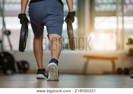 sport, bodybuilding, lifestyle and people concept - young man with Steel weights flexing muscles and