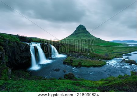 Picturesque landscape with cloudy sky on Kirkjufellsfoss waterfall. Amazing morning scene near Kirkjufell volkano, Iceland, Europe.