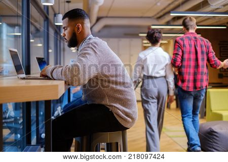 Young independent speacialists in coworking office.