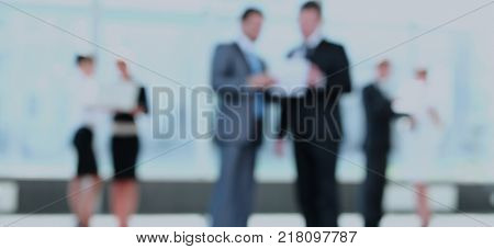 Confident business partners working in office and talking. Blurr