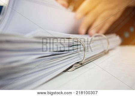 Hands business checking documents management folders in office for Annual Report files on Abstract blurred photo of businessman hands working with laptop computer. business busy concept