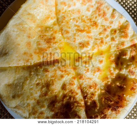 Hychin bread pie with potato stuffing. Traditional Caucasian cuisine - hot Ossetian pie.