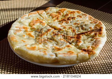 Hychin bread pie with potato stuffing. Traditional Caucasian cuisine - hot Ossetian pie.