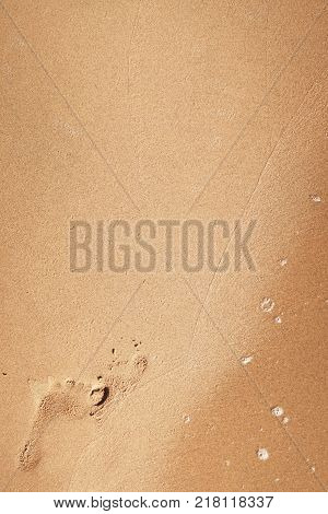 image of foot print on a sandy beach