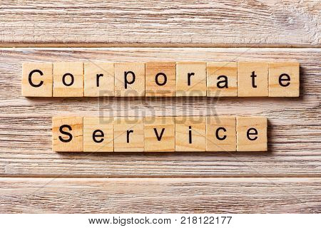 CORPORATE SERVICE word written on wood block. CORPORATE SERVICE text on table concept.