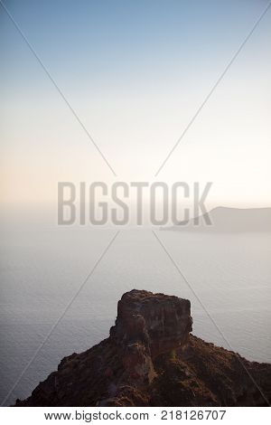 Santorini island, Greece. View on the foggy caldera and horizon through the famous Skaros Rock