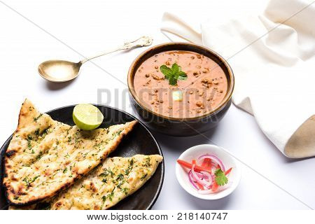 Dal makhani or dal makhni is a popular food from Punjab / India made using  whole black lentil, red kidney beans, butter and cream and served with garlic naan or Indian bread or roti