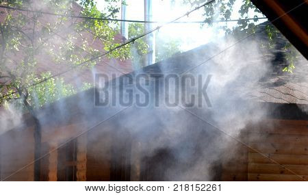 Irrigation system close-up. Humidification of air by steam on the street outdoor in a hot summer day morning