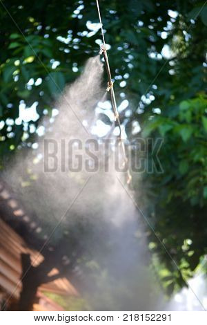 Irrigation system close-up. Humidification of air by steam on the street outdoor in a hot summer day morning