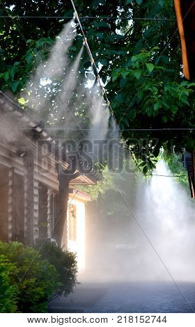 Irrigation system close-up. Humidification of air by steam on the street outdoor in a hot summer day morning