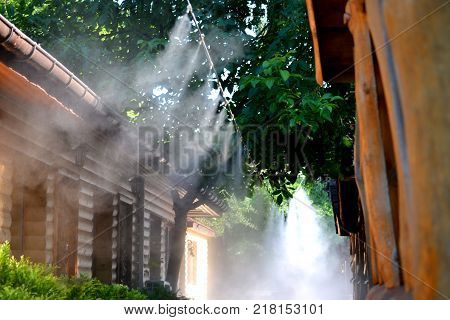 Irrigation system close-up. Humidification of air by steam on the street outdoor in a hot summer day morning
