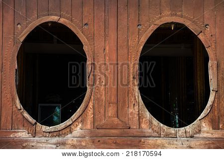 The big windows of Shwe Yaunghwe Kyaung monastery an iconic tourist attraction in Inle lake, Shan stateof Myanmar.