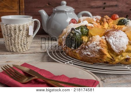 Merry Christmas cake with nuts - Bolo Rei is a traditional Xmas cake with fruits raisins nut and icing on wooden table.