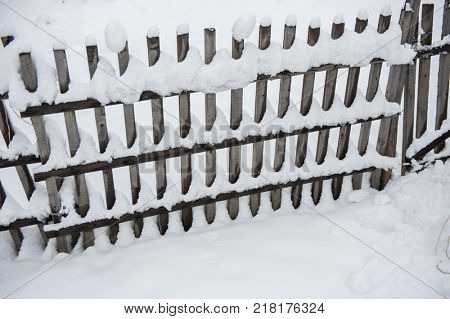 Country fence full of snow