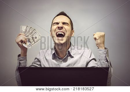 A Man Hammers A Nail Into Plaster Wall Under The Wallpaper
