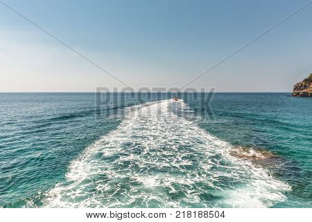 A trace on the surface of the Adriatic Sea behind a speed boat near the city of Budva, Montenegro.
