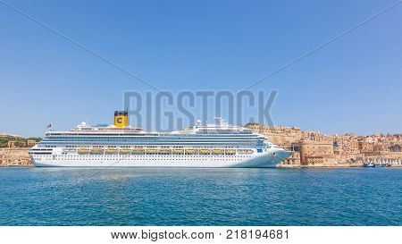 VALLETTA MALTA - JUNE 29 2012: The Costa Magica, a cruise ship of the Costa Crociere cruise, line moored alongside traditional buildings in Grand Harbour in Valletta, the capital city of Malta.
