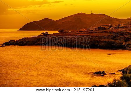 Beautiful sunrise over village Panormos at Crete island Greece
