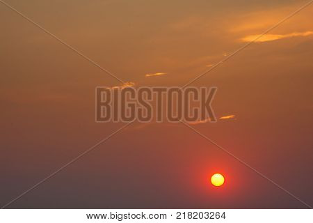 Red sun at sunset and clouds. Orange sun.