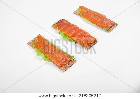 Low caloric open sandwich with red fish. Isolated on white background.