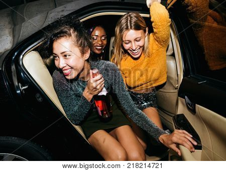 Diverse women in a backseat of a cab
