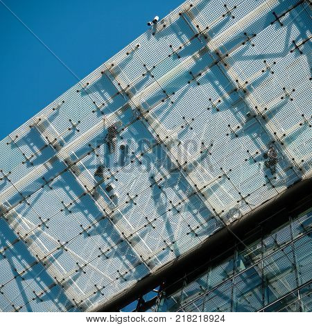 Fitters on a glass roof on a construction site in Berlin