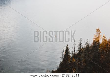 A small boat floats on the river far away