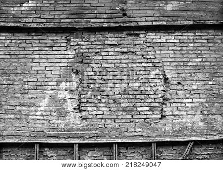 black and white old brick damage wall