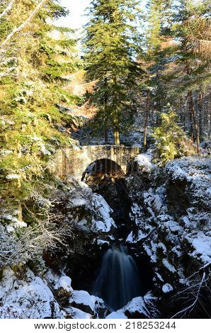 A view of the stone arch bridge over the falls of Bruar