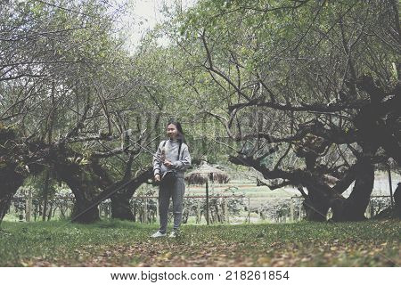 Tourist Use Smart Phone To Take Selfie Picture In Apricot Tree Orchard. People, Travel, Nature Conce
