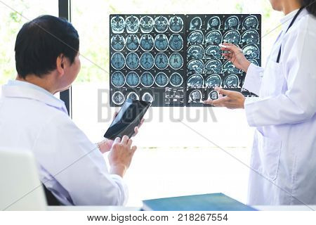 Professor Doctor discussing and consulting method with patient treatment results on brain x-ray film About the problem of the patient.