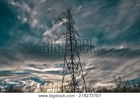 Electricity pylon on sunset, HDR image, colorful sky.