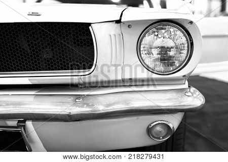Sankt-Petersburg Russia July 21 2017: Front view of Classic retro Ford Mustang GT390. Car exterior details. Headlight of a retro car. Black and white. Photo Taken on Royal Auto Show July 21